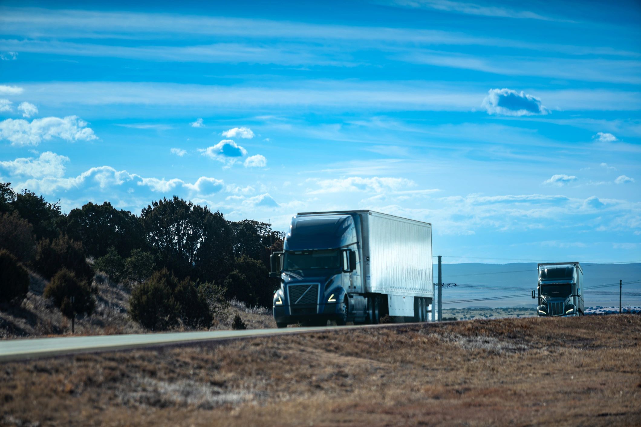 Semi-truck hauling a dry van trailer on an open highway